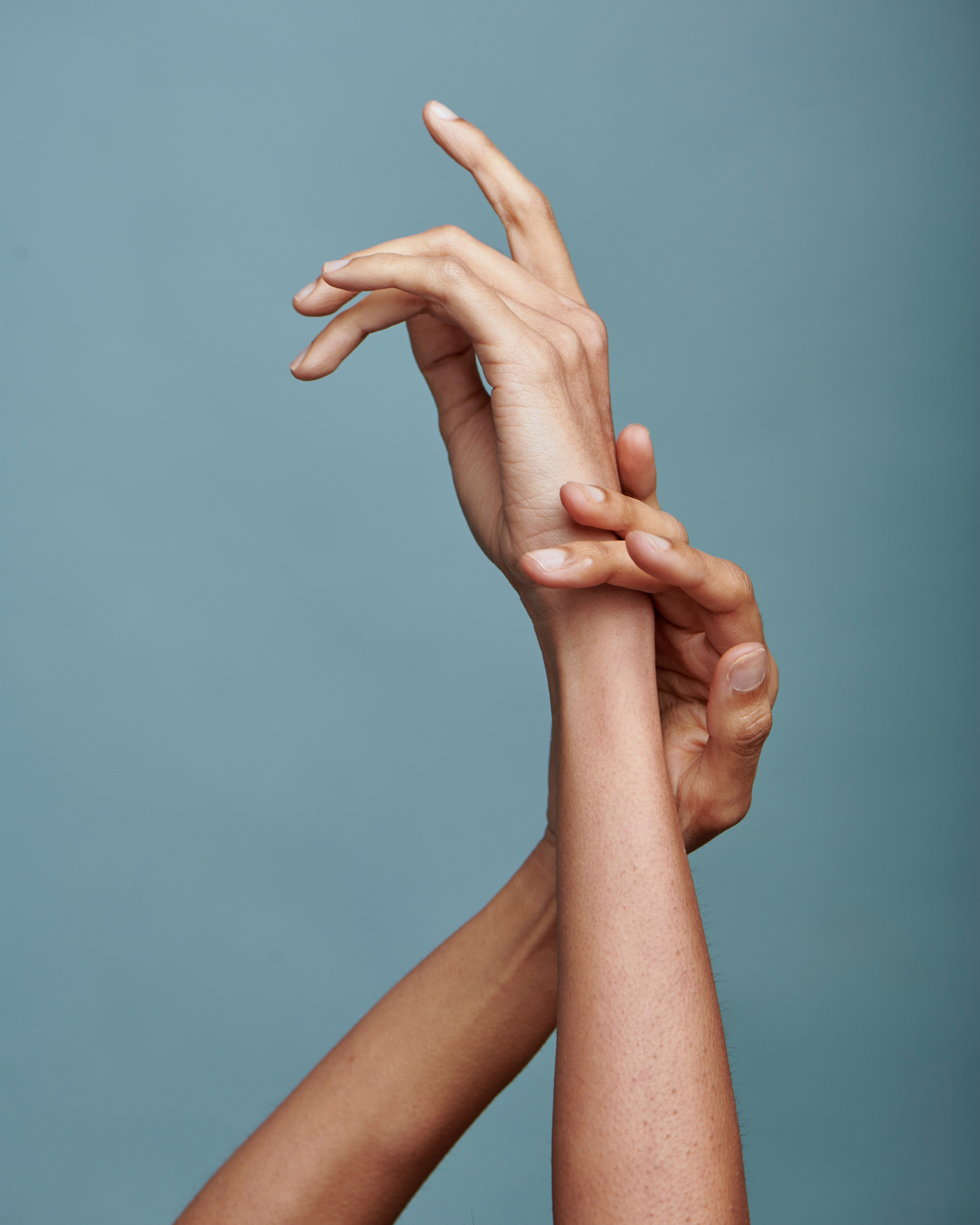 Smooth Female Hands on Blue Background